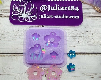 May include: A purple silicone mold with four flower shapes for making 1.25 inch holographic flower earrings. The mold is shown with two finished earrings.