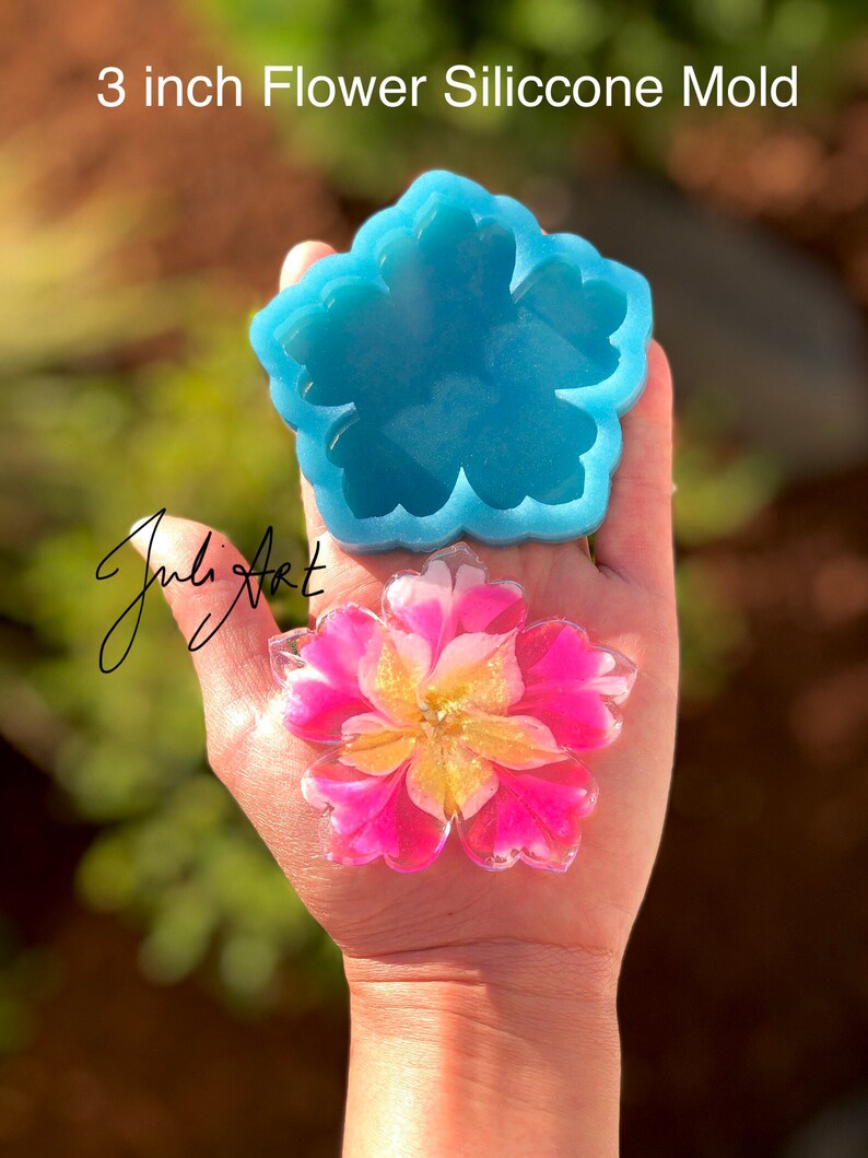May include: A 3 inch silicone flower mold with a light blue color. A pink and yellow resin flower is shown in the mold.
