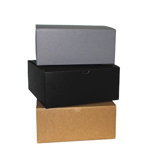 May include: Three boxes stacked on top of each other. The top box is gray, the middle box is black, and the bottom box is brown.