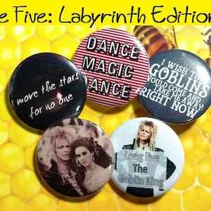 May include: Five round buttons with different designs. The buttons feature quotes from the movie Labyrinth, including "I move the stars for no one", "Dance Magic Dance", "I wish the goblins would come and take me away right now", and "Long live the Goblin King".