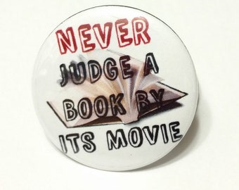 Never Judge A Book By Its Movie -1.25" or 1.5" - - Pinback Button - Magnet - Keychain