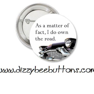 May include: A round button with a pin back. The button features a black and silver classic car image and the text "As a matter of fact, I do own the road." The website address www.dizzybeebuttons.com is printed below the button.