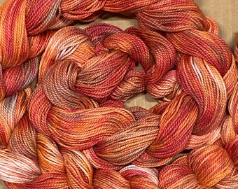 Hand-dyed pre-wound weaving warps, 3/2 ring spun cotton, 6 5/8 yards, multiple ends, in shades of brick red, pink, peach, and  taupe - DW291