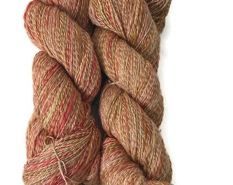 Hand-dyed yarn, 70% cotton & 30 acrylic, 436 yard skeins, in shades of beige, dark salmon, pinkish brown, red, and white
