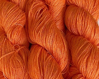 Hand-dyed 8/2 cotton and rayon, 532 yard skein and 700 yard skeins, in tonal shades of medium peachy orange