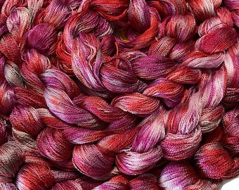 Hand-dyed pre-wound weaving warp, 8/2 Tencel/lyocell, 14 1/2 yards, 196 ends, in shades of red, red purple, pink, and pale pink - DW283