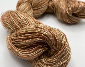 Hand-dyed 8/2 rayon yarn, 350 yard skeins, in shades of golden brown, beige, brown, copper, and small amounts of light to pale green-DY189