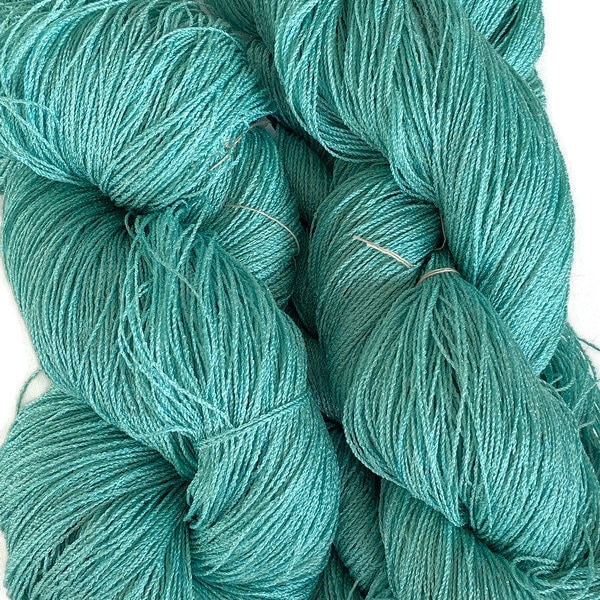 Hand-dyed 8/2 cotton and rayon yarn, 182 and 875 yard skeins, in tonal shades of blue-green