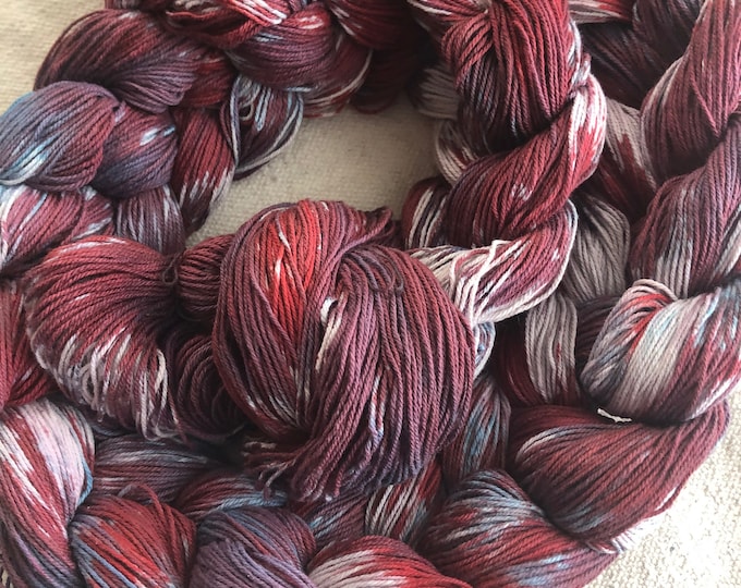 Hand-dyed, pre-wound, weaving warp chain, 10/3 cotton, 140 ends, 5 5/8 yards long, in shades of red, purple, blue, and natural - DW224