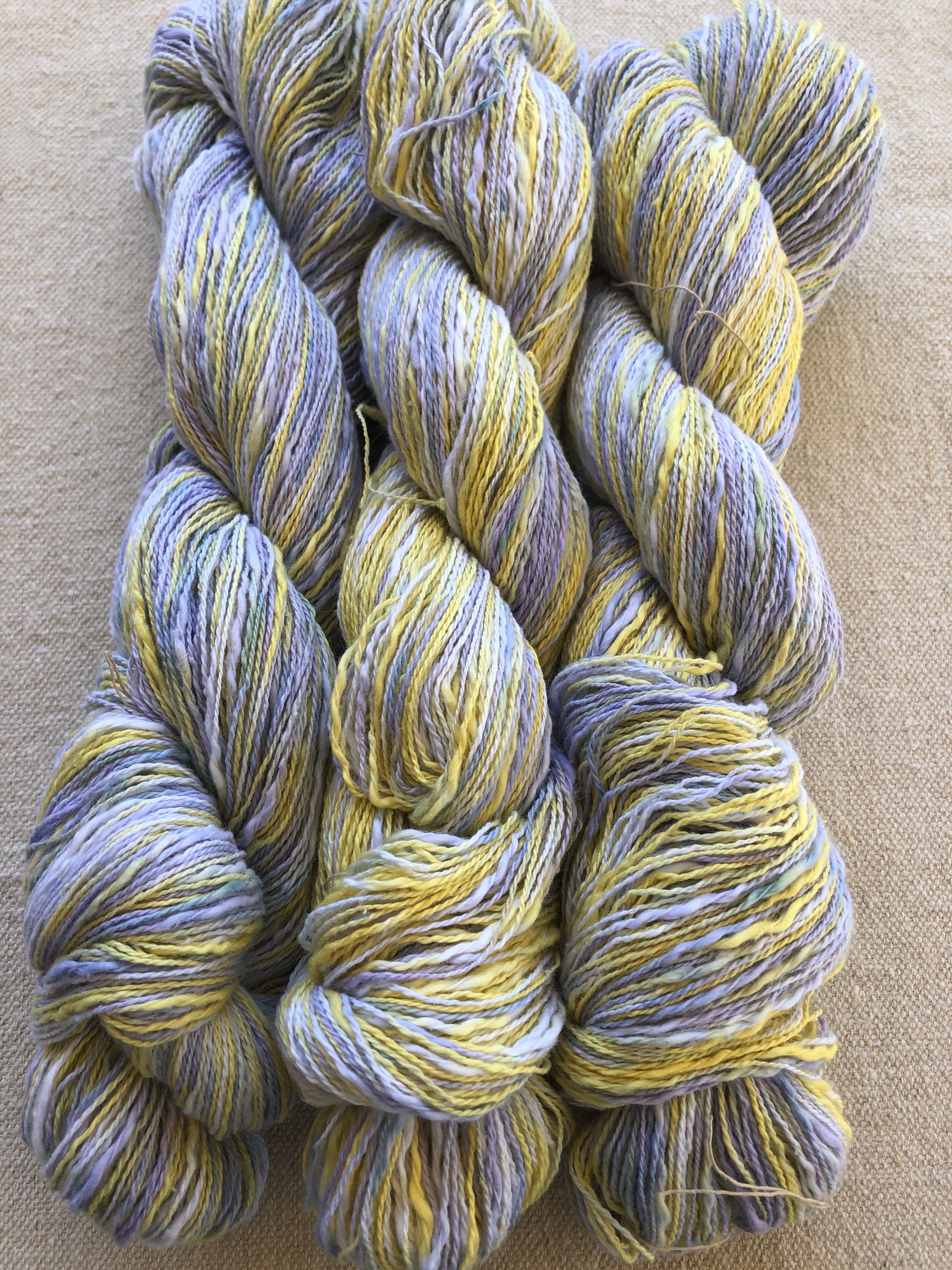 Hand-dyed, 2-ply cotton, thick and thin yarn, 500 yard skeins, in shades of  yellow, lavender, and blue