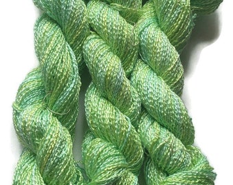 Hand-dyed rayon krinkle yarn, 200 yard skeins, in shades of bright green, light green, yellow-green, and yellow