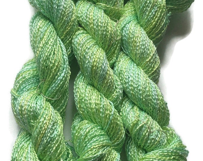 Hand-dyed rayon krinkle yarn, 200 yard skeins, in shades of bright green, light green, yellow-green, and yellow
