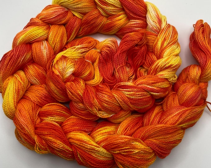 Hand-dyed pre-wound weaving warp, 8/2 ring spun cotton, 4 7/8 yards, in shades of yellow, orange, peach, orange red, and natural - DW304
