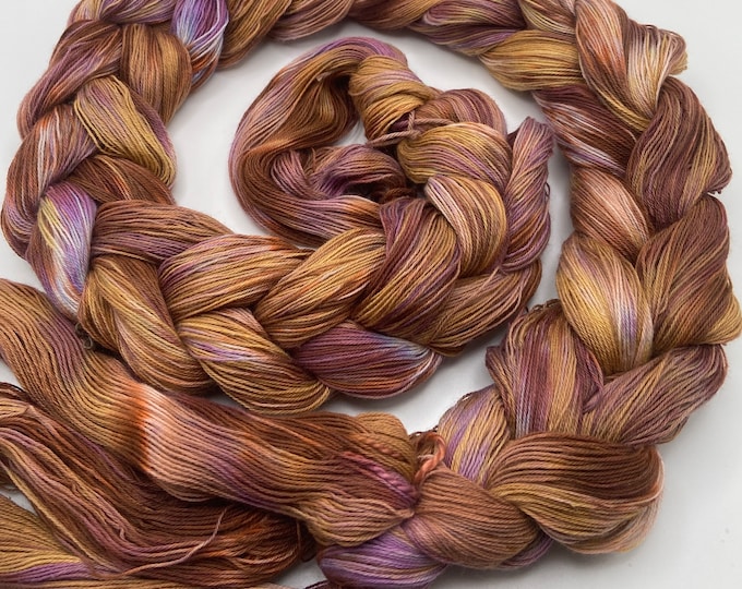 Hand-dyed pre-wound weaving warps, 24/3 cotton, 4 7/8 yards, in shades of purple, lavender, golden brown, brown, peach, and natural - DW301