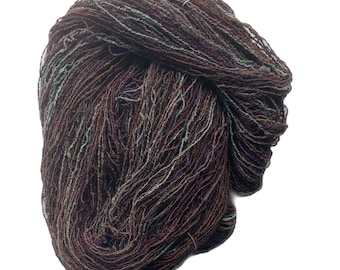 Hand-dyed cotton/rayon boucle yarn, 400 yard skeins, in shades of brown, green, sage green, purple, and red brown