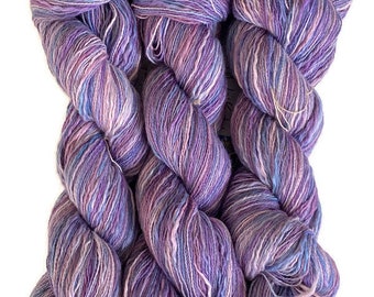 Hand-dyed cotton thick and thin yarn, 525 yard skeins, in shades of medium blue, light blue, purple, lavender, and pink