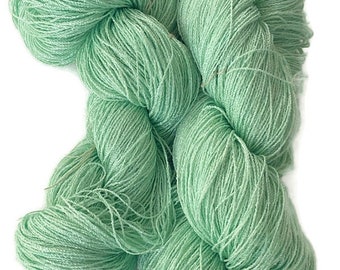 Hand-dyed 8/2 cotton and rayon yarn, 400 yard skein and 700 yard skein, in tonal shades of light bright green