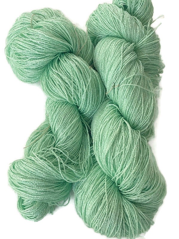 Hand-dyed 8/2 cotton and rayon yarn, 400 yard skein and 700 yard skein, in  tonal shades of light bright green