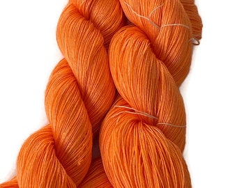Hand-dyed 8/2 rayon yarn, 590 yard skein and 875 yard skein, in tonal shades of bright orange