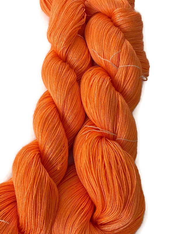 Hand-dyed 8/2 rayon yarn, 590 yard skein and 875 yard skein, in tonal  shades of bright orange