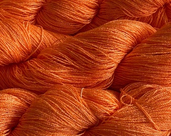 Hand-dyed 8/2 cotton and rayon, 532 yard skein and 700 yard skeins, in tonal shades of medium peachy orange