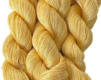 Hand-dyed 8/2 rayon yarn, 486 yard skeins and 890 yard skein, in tonal shades of medium golden yellow