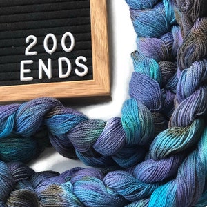 Hand-dyed, pre-wound weaving warp chain, 8/2 ring spun cotton, 3 3/4 yards, multiple ends, in shades turquoise, lavender, and brown DW265 200 ends