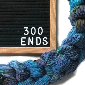 Hand-dyed, pre-wound weaving warp chain, 8/2 ring spun cotton, 3 3/4 yards, multiple ends, in shades turquoise, lavender, and brown DW265 300 ends