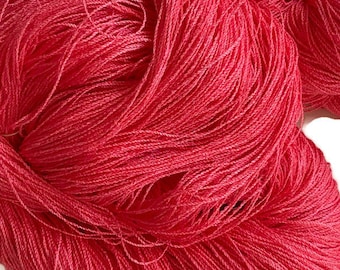 Hand-dyed 8/2 cotton and rayon yarn, 700 and 786 yard skeins, in tonal shades of pinkish orange