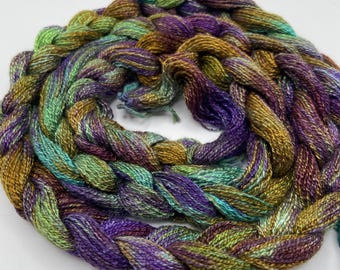 Hand-dyed pre-wound weaving warp, 8/2 Tencel/lyocell, 5 3/4 yards, in shades of purple, bronze, green, turquoise, and red purple - DW324