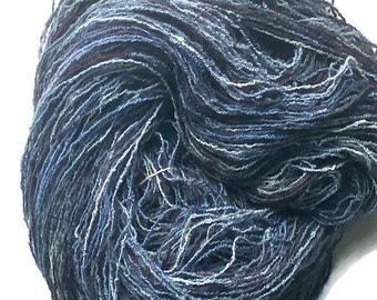 Hand-dyed cotton/rayon boucle yarn, 400 yard skeins, in shades of black, navy, blue, light blue, and grey