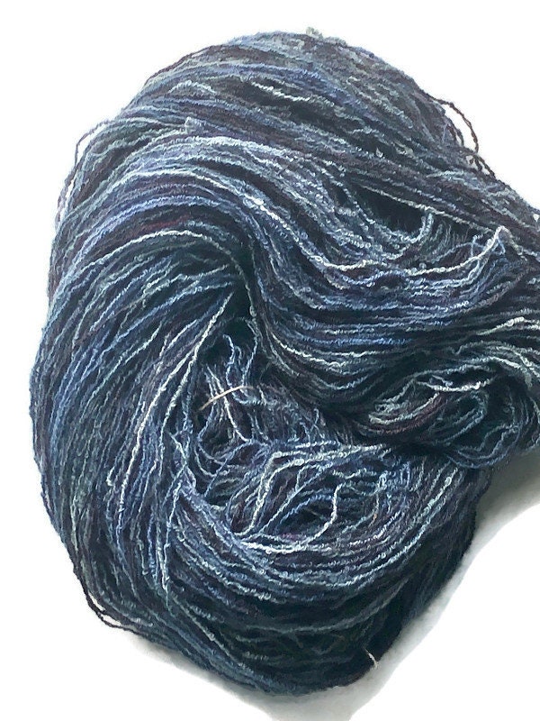 Hand-dyed cotton/rayon boucle yarn, 400 yard skeins, in shades of black,  navy, blue, light blue, and grey