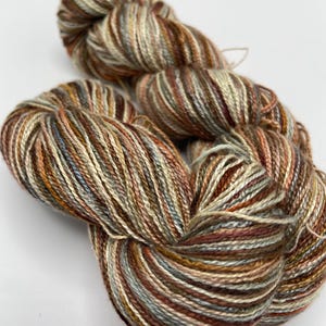 Hand-dyed 8/2 rayon yarn, 393 yard skeins, in shades of brown, grey, cream, peach, sage, and burnt orange -DY197