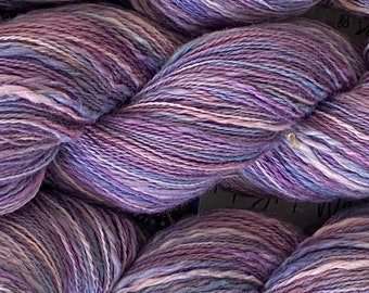 Hand-dyed cotton thick and thin yarn, 525 yard skeins, in shades of medium blue, light blue, purple, lavender, and pink