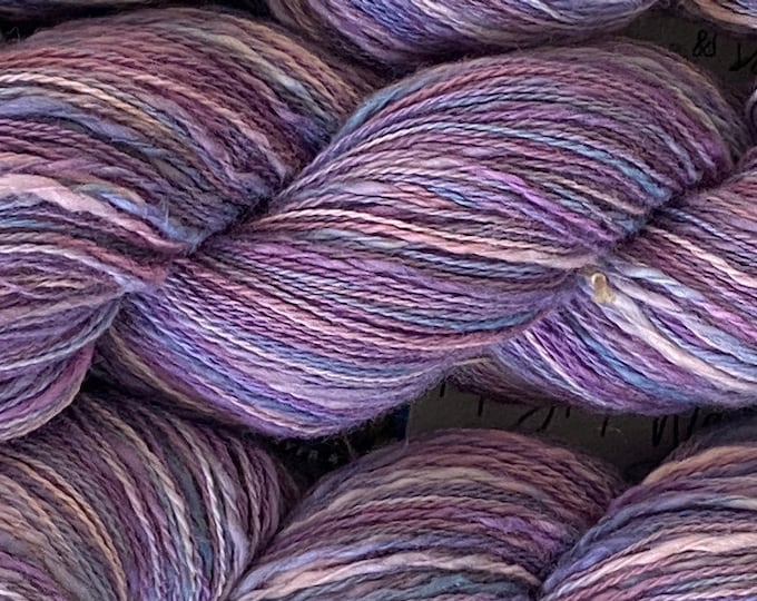 Hand-dyed cotton thick and thin yarn, 525 yard skeins, in shades of medium blue, light blue, purple, lavender, and pink