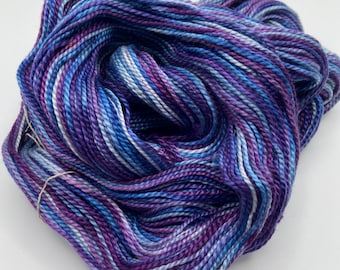 Hand-dyed mercerized 3/2 cotton, 175 yard skeins, in shades of blue, purple, light blue, lavender, red purple, pale blue, and white-DY193