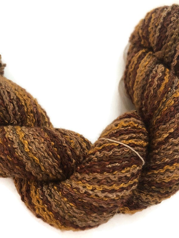 Hand-dyed, cotton and rayon, boucle yarn, 200 yard skeins, in shades dark  brown, golden brown, and beige