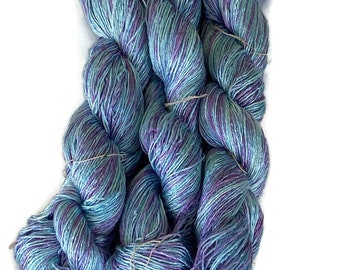 Hand-dyed rayon floss yarn, 6 ply/strand, 350 yards skeins, in shades of sky-blue, light blue, lavender, and medium purple