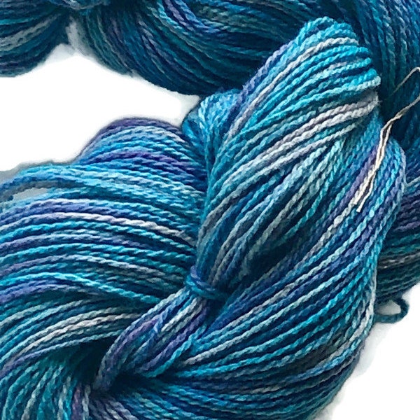 Hand-dyed 2-ply cotton yarn, 400 yard skeins, in shades of turquoise, purple, lavender, light blue, and grey