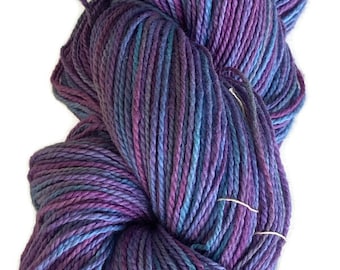 Hand-dyed cotton yarn, 350 yard skeins, in shades of turquoise, blues, purples, lavender, and red purple