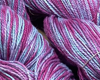 Hand-dyed cotton yarn, 4.5/2 cotton, 350 yards, in shades of light blue, lavender, red purple, and pink