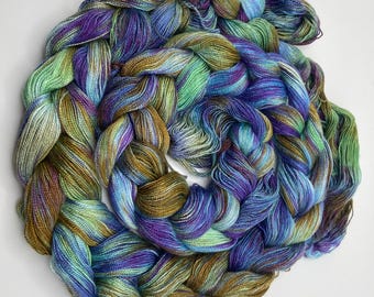 Hand-dyed pre-wound weaving warp, 8/2 rayon, 5 5/8 yards, in shades of purple, blue, light blue, green, bronze, and red purple -DW318