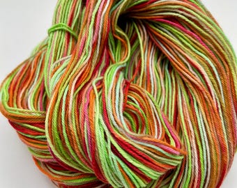 Hand-dyed 12/4 cotton, 306 yard skeins, in shades of red, raspberry, pink, green, lime green, orange, peach, and small bits of white -DY194