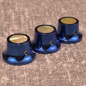 Custom guitar knob set. Color anodized titanium with Gold Mother of Pearl inlay.