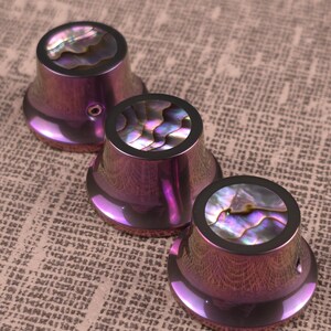 Custom guitar knob set. Color anodized titanium with Abalone inlay.
