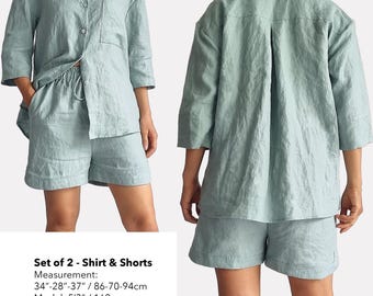 May include: A set of two light blue linen clothing items: a shirt with a button-up front and a pocket, and matching shorts. The model is wearing the set and is 5'3" tall.  The text on the image reads: "bay bay" and "baybaylinen.com".  Set of 2 - Shirt & Shorts Measurement: 34"-28"-37"/86-70-94cm Model: 5'3"/160cm