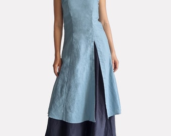 May include: A light blue sleeveless tunic with thin spaghetti straps, a scoop neckline, and a long front slit, layered over a dark navy blue floor-length skirt. The text bay bay baybaylinen.com is visible in the bottom right corner.