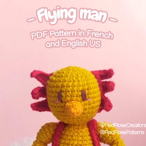 May include: A handmade crochet doll in the shape of a character from the video game "Earthbound." The doll is yellow with red accents, wearing red overalls and white-trimmed socks. Text on the image reads "Flying man" and "PDF Pattern in French and English US."