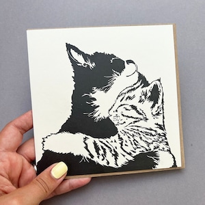 Beautiful Letterpress printed card of two kittens cuddling. One Tabby and one black and white kitten having a snuggle.