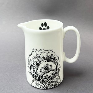 The front of the half pint jug with a very cute Cockapoo and a paw print on the inside.